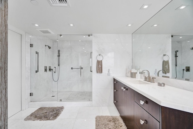 bathroom featuring walk in shower and vanity