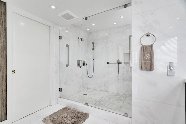 bathroom featuring a shower with door and tile patterned floors