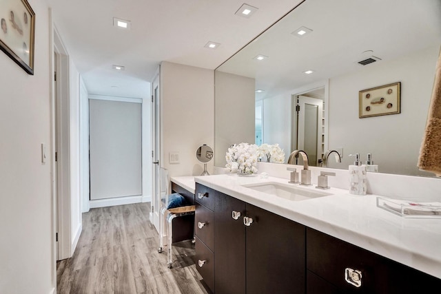 bathroom with vanity and hardwood / wood-style flooring