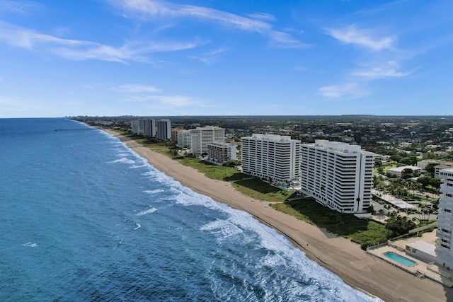 birds eye view of property with a water view and a view of the beach