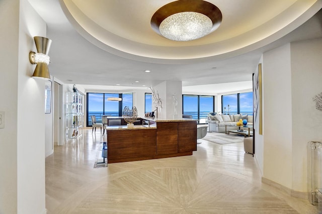 living room featuring a raised ceiling and radiator heating unit