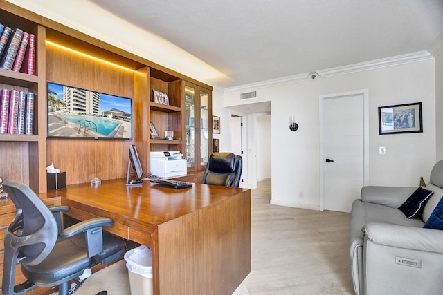 home office with light hardwood / wood-style flooring and crown molding