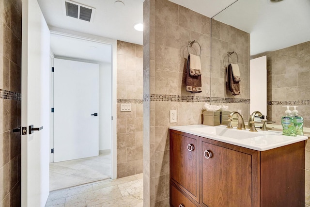 bathroom featuring tile walls and vanity