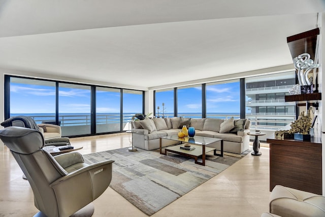 living room featuring a water view and expansive windows