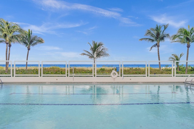 view of swimming pool with a water view