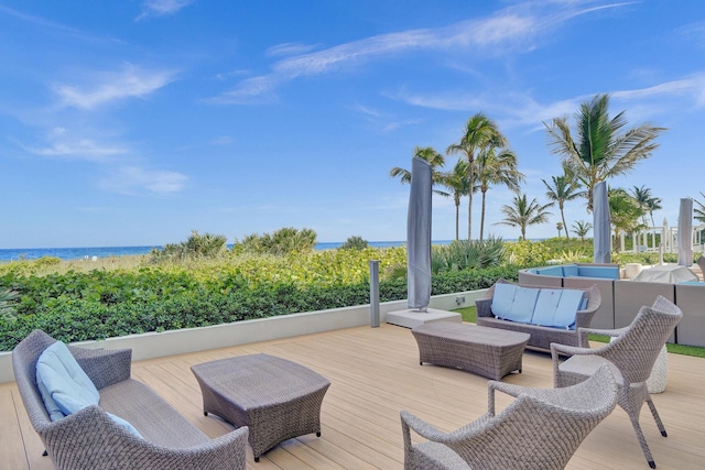 deck featuring a water view and outdoor lounge area