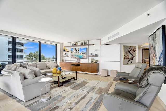 living room with light hardwood / wood-style flooring and a wall of windows