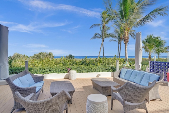 wooden terrace featuring an outdoor hangout area and a water view