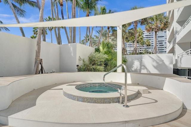 view of swimming pool featuring a hot tub