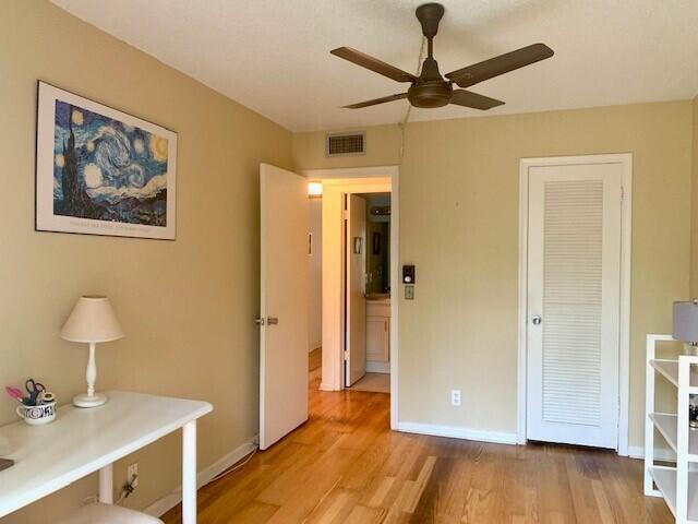 unfurnished bedroom with ceiling fan and light wood-type flooring