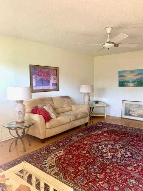 living room featuring hardwood / wood-style flooring and ceiling fan