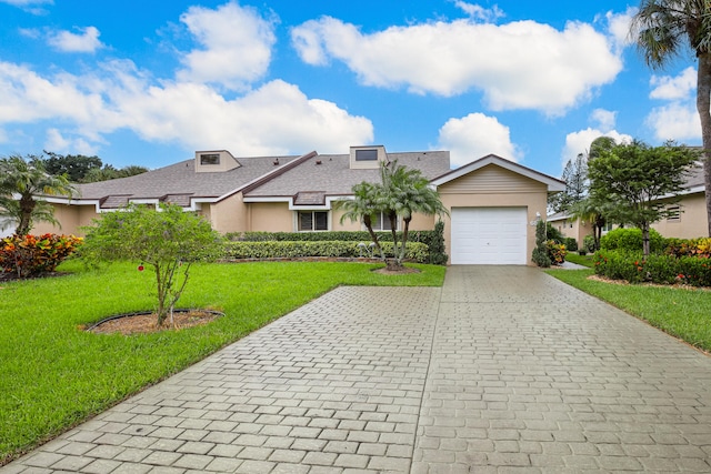 single story home with a front yard and a garage