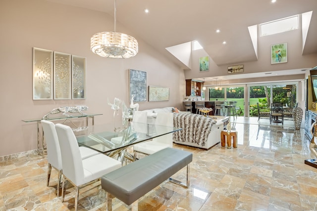 dining room featuring high vaulted ceiling and a chandelier