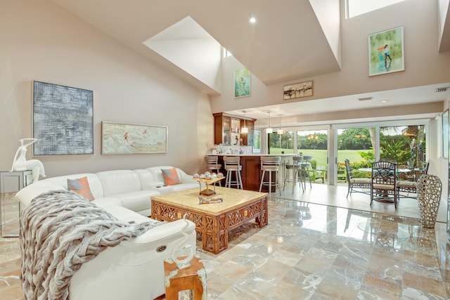 living room with high vaulted ceiling