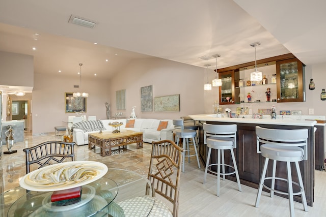 dining room with vaulted ceiling and a notable chandelier