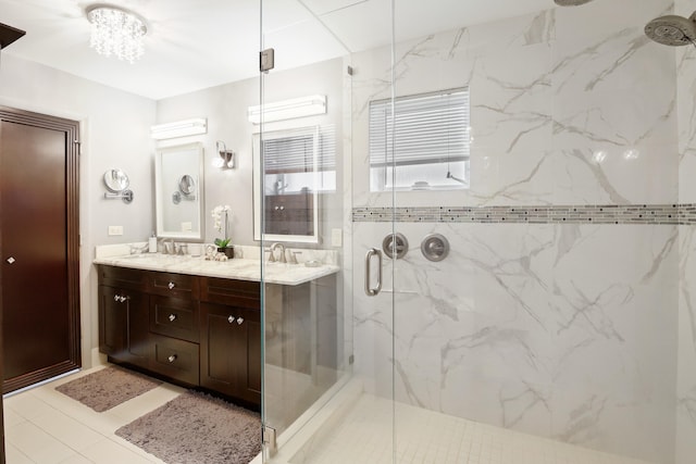 bathroom featuring a shower with door, vanity, and tile patterned flooring