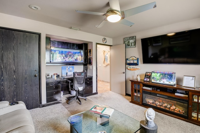 carpeted living room featuring ceiling fan