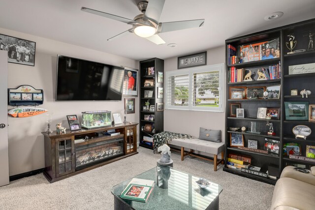 carpeted living room with ceiling fan