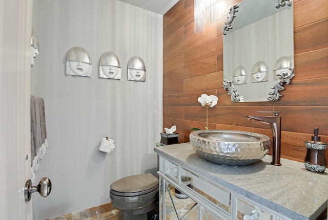 bathroom featuring vanity, tasteful backsplash, and toilet