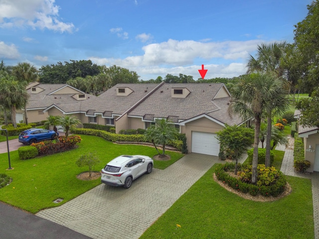 view of front of property featuring a garage and a front yard