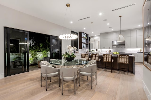 dining space featuring light wood-type flooring