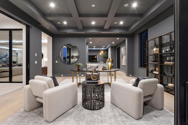 office space with a water view, light hardwood / wood-style floors, coffered ceiling, and beam ceiling