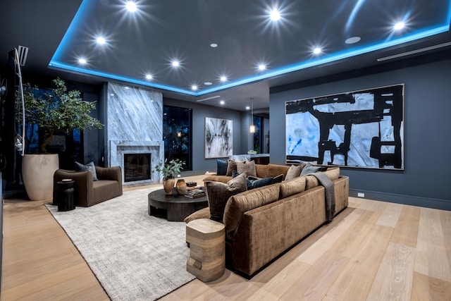 kitchen featuring beam ceiling, hanging light fixtures, a kitchen island, light stone countertops, and coffered ceiling