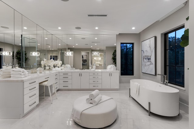 bathroom featuring vanity and a bath