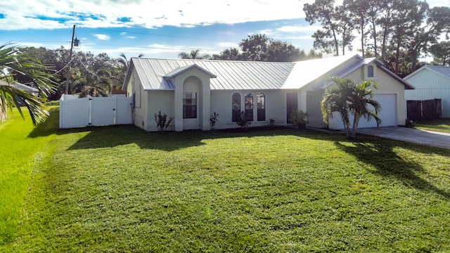 view of front of home featuring a garage and a front lawn