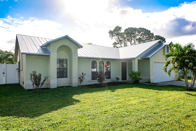 single story home with a front yard and a garage