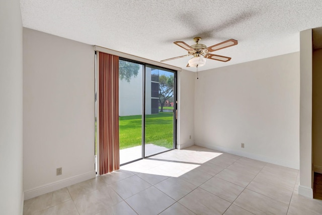 tiled spare room featuring ceiling fan and a textured ceiling