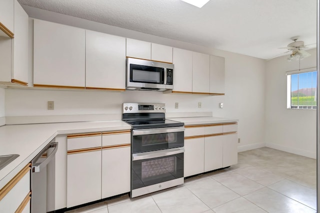 kitchen with a textured ceiling, white cabinetry, ceiling fan, and stainless steel appliances