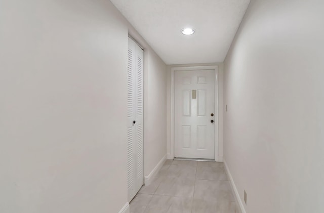 hall featuring light tile patterned floors