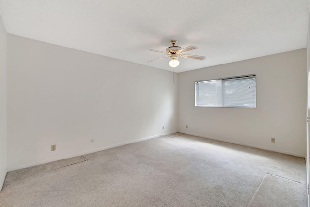 unfurnished room featuring ceiling fan and light colored carpet