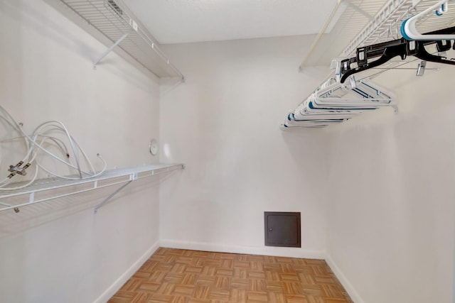 spacious closet featuring light parquet flooring