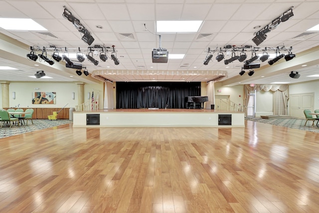 miscellaneous room featuring a drop ceiling and hardwood / wood-style floors