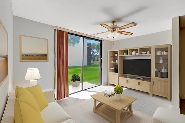 living room with ceiling fan and light tile patterned flooring