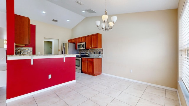 kitchen with tasteful backsplash, kitchen peninsula, a chandelier, a breakfast bar, and appliances with stainless steel finishes