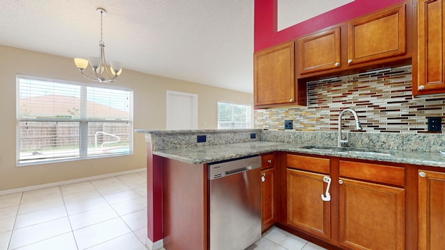 kitchen featuring dishwasher, sink, tasteful backsplash, light stone counters, and a chandelier