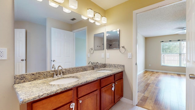 bathroom with vanity, hardwood / wood-style floors, and a textured ceiling