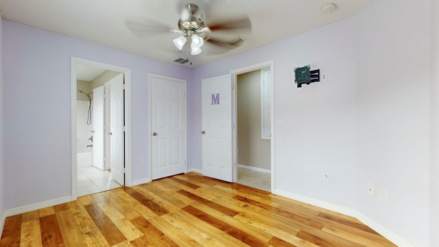 unfurnished bedroom with ceiling fan and light hardwood / wood-style floors