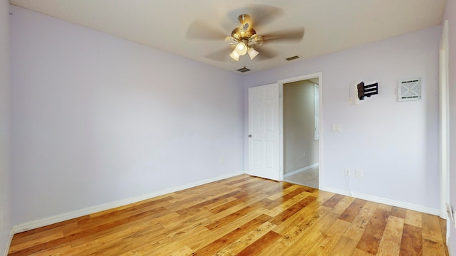 unfurnished room with light wood-type flooring and ceiling fan