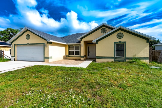 ranch-style home featuring a front lawn and a garage