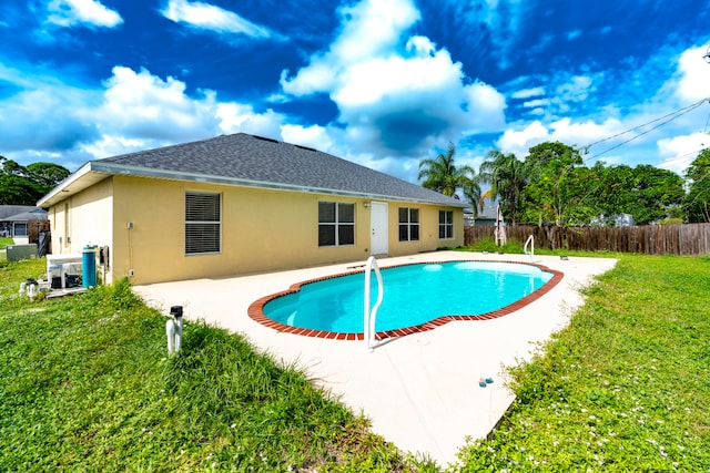 view of pool featuring a yard and a patio