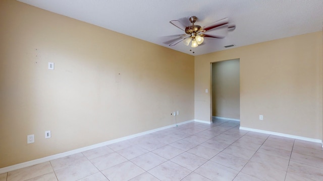 unfurnished room featuring ceiling fan and light tile patterned floors