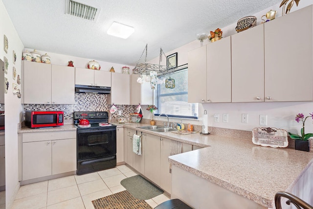 kitchen with sink, decorative backsplash, light tile patterned floors, a textured ceiling, and black / electric stove