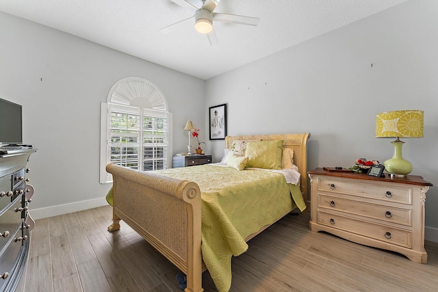 bedroom with hardwood / wood-style floors and ceiling fan