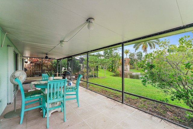 unfurnished sunroom with a water view