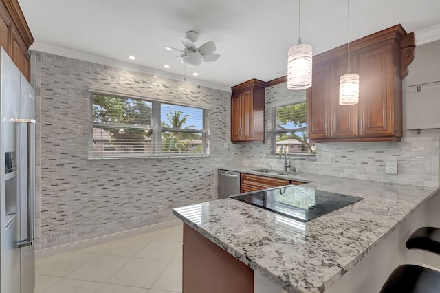 kitchen with kitchen peninsula, appliances with stainless steel finishes, decorative light fixtures, light stone countertops, and ceiling fan