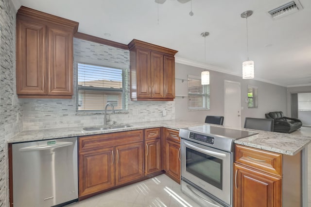 kitchen with pendant lighting, stainless steel appliances, sink, and kitchen peninsula